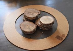 three pieces of wood sitting on top of a wooden plate