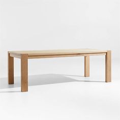 a wooden table sitting on top of a white floor