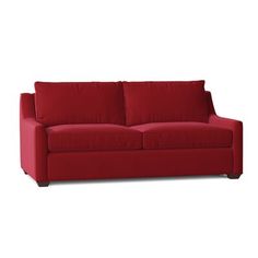 a red couch sitting on top of a white floor