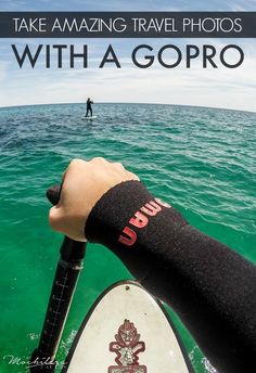 a person in the water with their arm wrapped around a surfboard and text that reads take amazing travel photos with a gopro