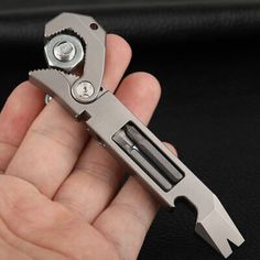 a hand holding a multi - tool in it's right hand, with the other part visible