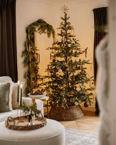 a living room with a christmas tree in the corner and other decorations on the table