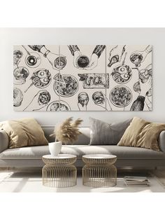 a living room scene with focus on the couch and wall art above it, along with two chairs