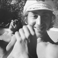 black and white photograph of two men in the pool with one pointing at the camera