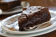 a piece of chocolate cake on a plate with a fork