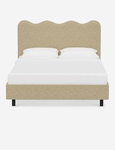 an upholstered bed with white sheets and headboard, made in beige fabric