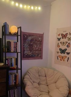 a living room filled with furniture and bookshelves next to a wall mounted tv