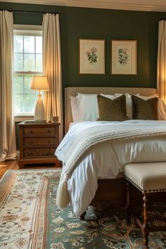 a bedroom with green walls and white bedding