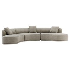 a curved couch with pillows on the top and bottom corner, in light grey fabric