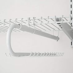 there is a white shelf with hooks on it