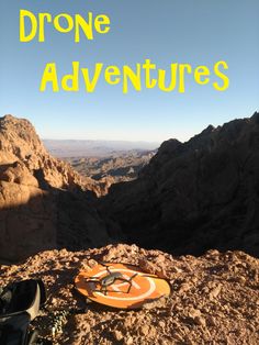 an orange plate sitting on top of a rocky mountain next to a pair of sunglasses