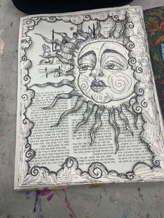 a drawing of the sun on top of a piece of paper with writing underneath it