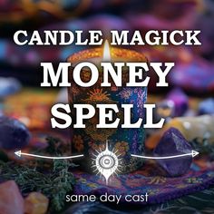 a candle with the words candle magic money spell in front of it and some rocks