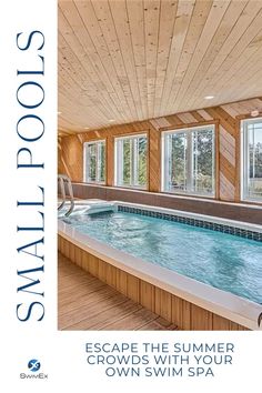 an indoor jacuzzi is shown with windows and wood paneling on the walls