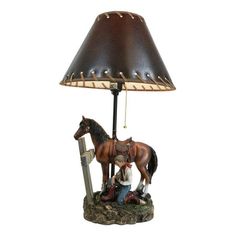 a lamp with a horse on it and a person next to it holding a saddle