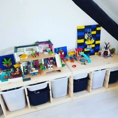 the children's playroom is filled with toys and storage bins for them