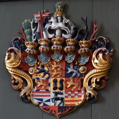 an ornate coat of arms on the side of a building