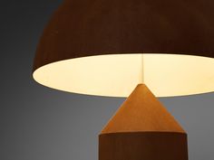 a brown lamp with a white light on it's side and a dark background