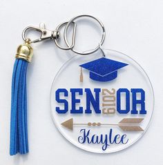 a keychain with a graduation cap and tassel hanging from it's side