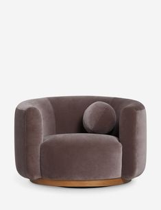 a grey chair with two round cushions on it's back and one in the middle