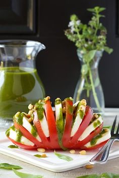 a white plate topped with sliced vegetables on top of a table