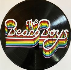 a record with the words the beach boys painted on it's side in rainbow colors