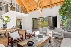 a living room filled with furniture and a wooden ceiling