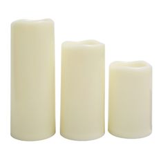 three white candles sitting next to each other