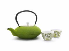 a green tea pot with two cups next to it