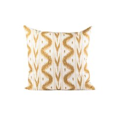 a gold and white pillow with an intricate design on the front, sitting against a white background