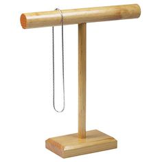 a wooden stand with a chain hanging from it's end and a piece of wood attached to the pole