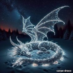 a glowing dragon sitting on top of a snow covered ground in front of the night sky