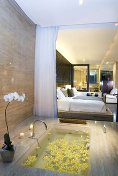 a bathroom with a jacuzzi tub filled with yellow flowers