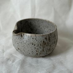 a white and gray bowl sitting on top of a table