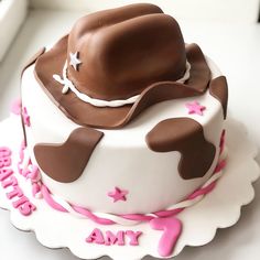 a birthday cake with a cowboy hat on top