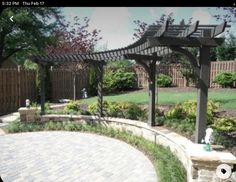 an outdoor patio area with brick pavers and pergolated trellis on the side