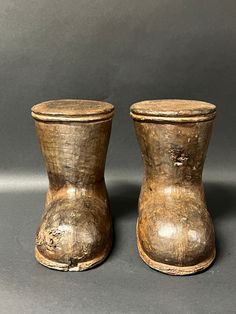 two wooden vases sitting on top of a table