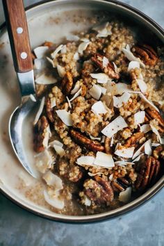 a bowl filled with oatmeal and pecans on top of a table