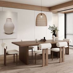 a dining room table with white chairs and a vase on the wall next to it