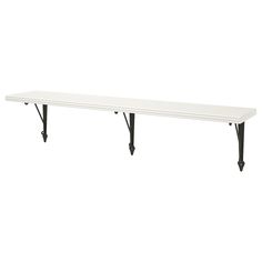 a white table with black legs and a long shelf on the top that has two hooks attached to it