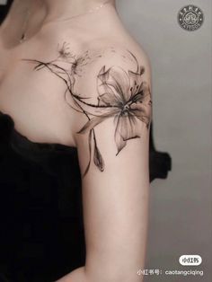 a woman with a flower tattoo on her shoulder