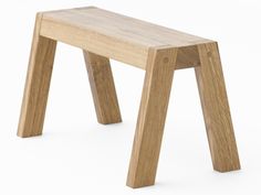 a wooden stool sitting on top of a white floor