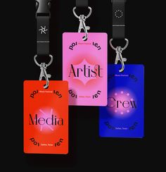 four different colored tags with the word artist on them and one has a pair of scissors hanging from it