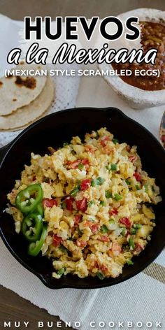 mexican style scrambled eggs in a cast iron skillet on a table with tortillas