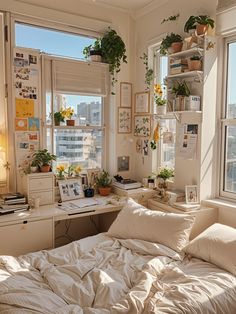 an unmade bed sitting next to two windows with plants on the window sill