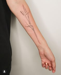 a woman's arm with a flower tattoo on it