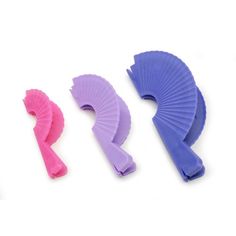 three different types of plastic hair clips on a white surface, one purple and one pink