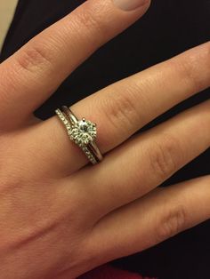 a woman's hand with a diamond ring on it