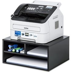 a printer sitting on top of a black and white shelf next to other office supplies