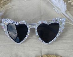 a pair of heart shaped sunglasses sitting on top of a table